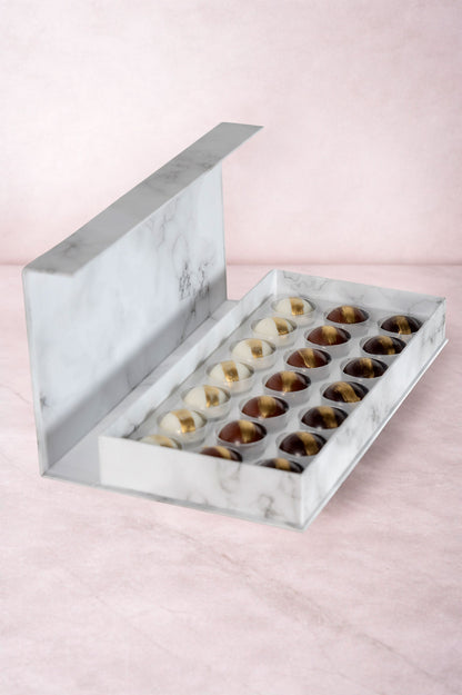 Caja Blanca de 21 Chocolates Días Positivos Relleno Dubai con Pistache y Kataifi Fondo Marmol